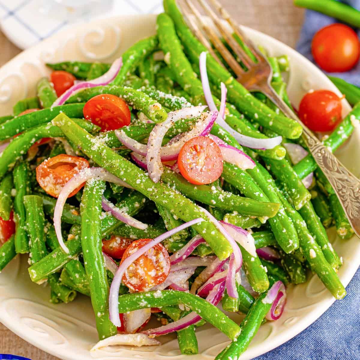 Close up of Marinated Green Bean Salad in bowl showing all ingredients.