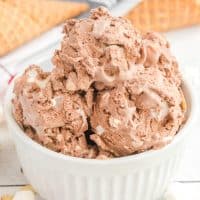 Close up square image of No-Churn Rocky Road Ice Cream in white Ramekin showing the ingredients mixed in.
