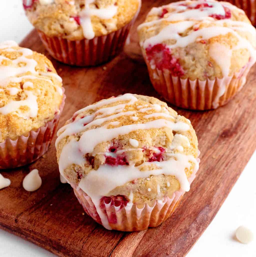 Close up square image of finished glazed Raspberry White Chocolate Muffins.