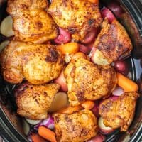 Square close up image of Slow Cooker Chicken Thighs Meal in slow cooker.