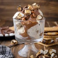 Square image of S'mores Magic Shell over ice cream in glass parfait dish.