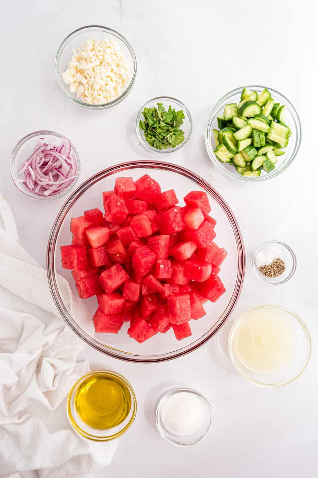 Ingredients needed: ime juice, granulated sugar, kosher salt, pepper, olive oil, watermelon, baby cucumbers, red onion, feta cheese and mint leaves.