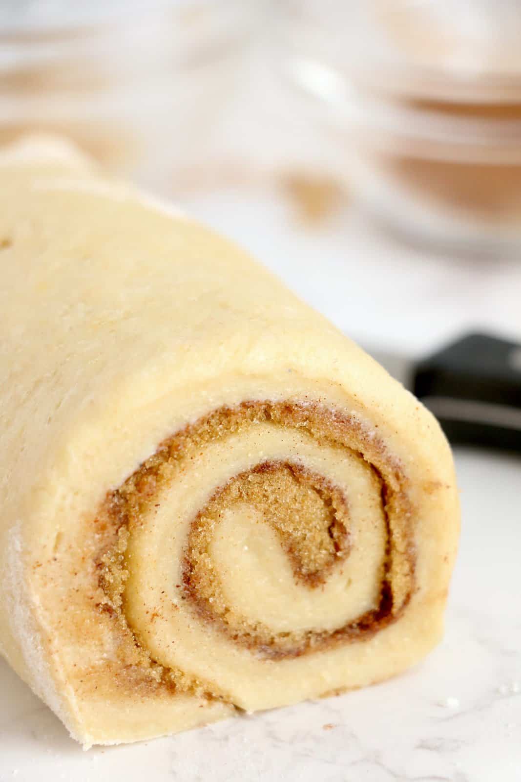 Cinnamon roll dough rolled up.