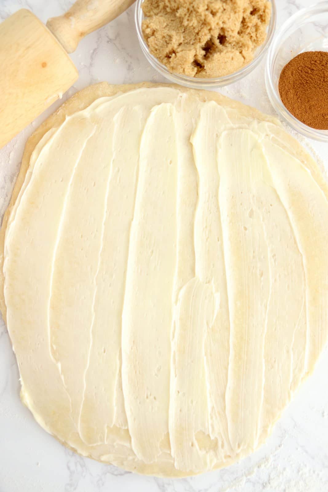 Butter spread out over rolled out dough.