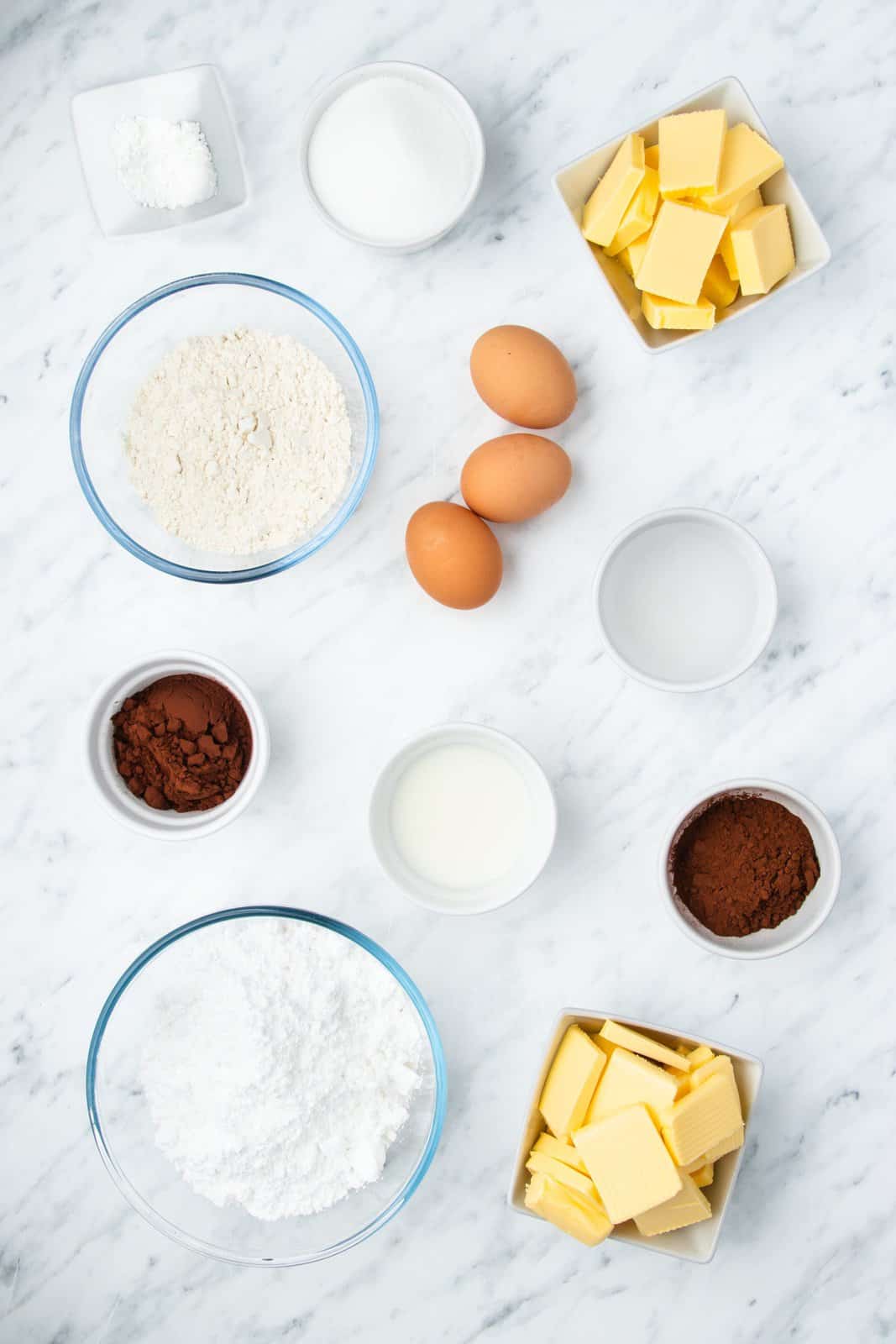 Ingredients needed: cocoa powder, boiling water, eggs, unsalted butter, granulated sugar, all-purpose flour, baking powder, powdered sugar, milk and chocolate sprinkles.