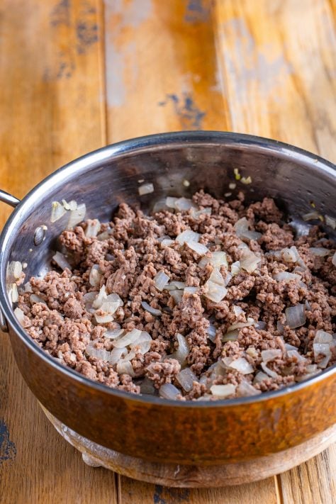 Ground beef and onions in a pot.