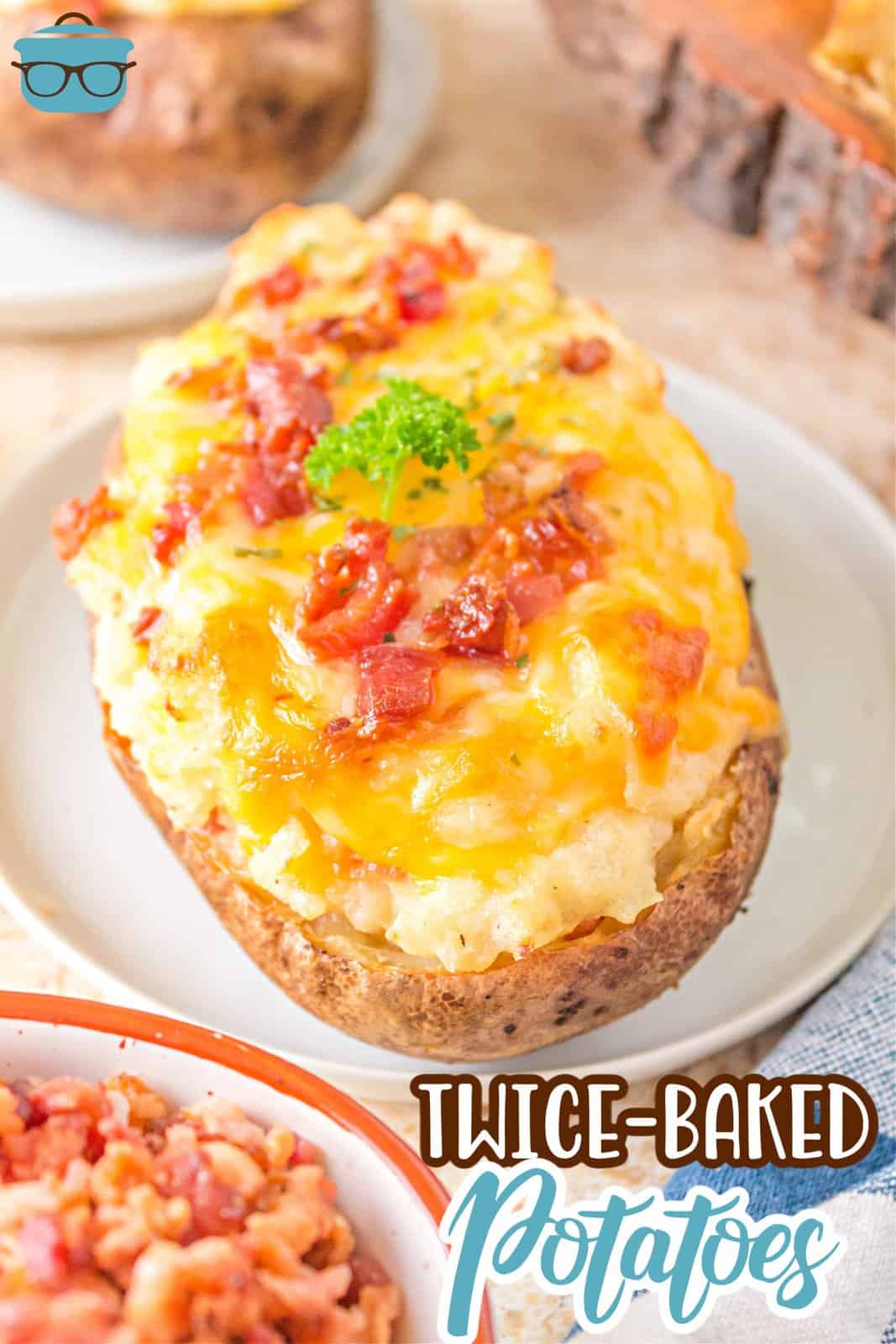 Pinterest image of one of the Grilled Twice Baked Potatoes on white plate with toppings.