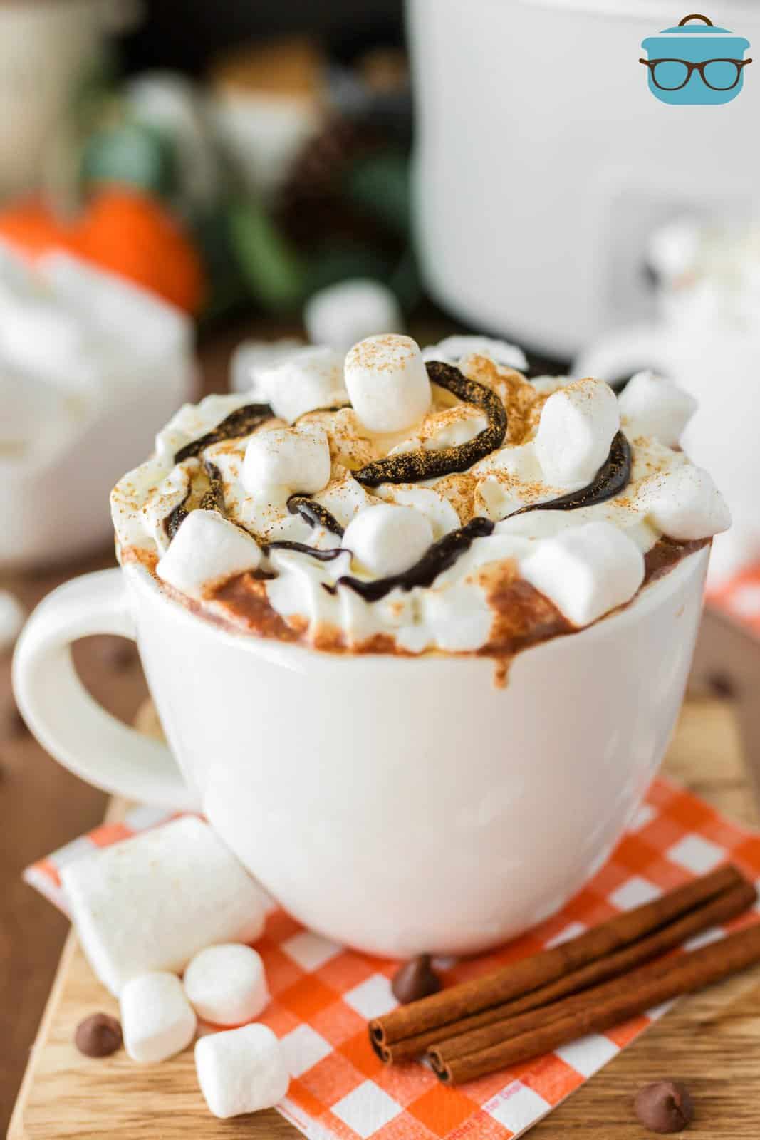 Crock Pot Pumpkin Hot Chocolate in mug with garnishes.