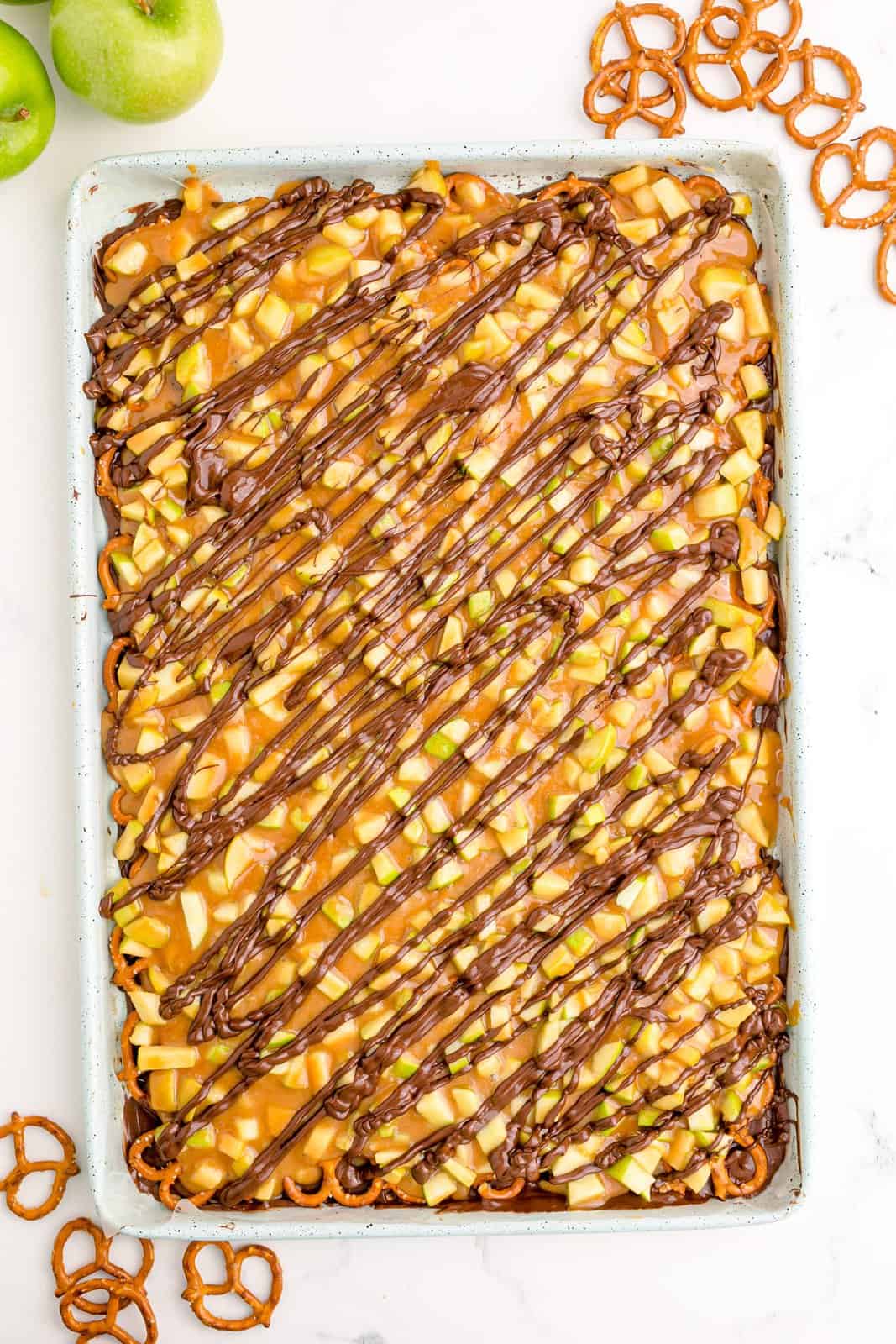Remaining chocolate drizzled over caramel apple toping.