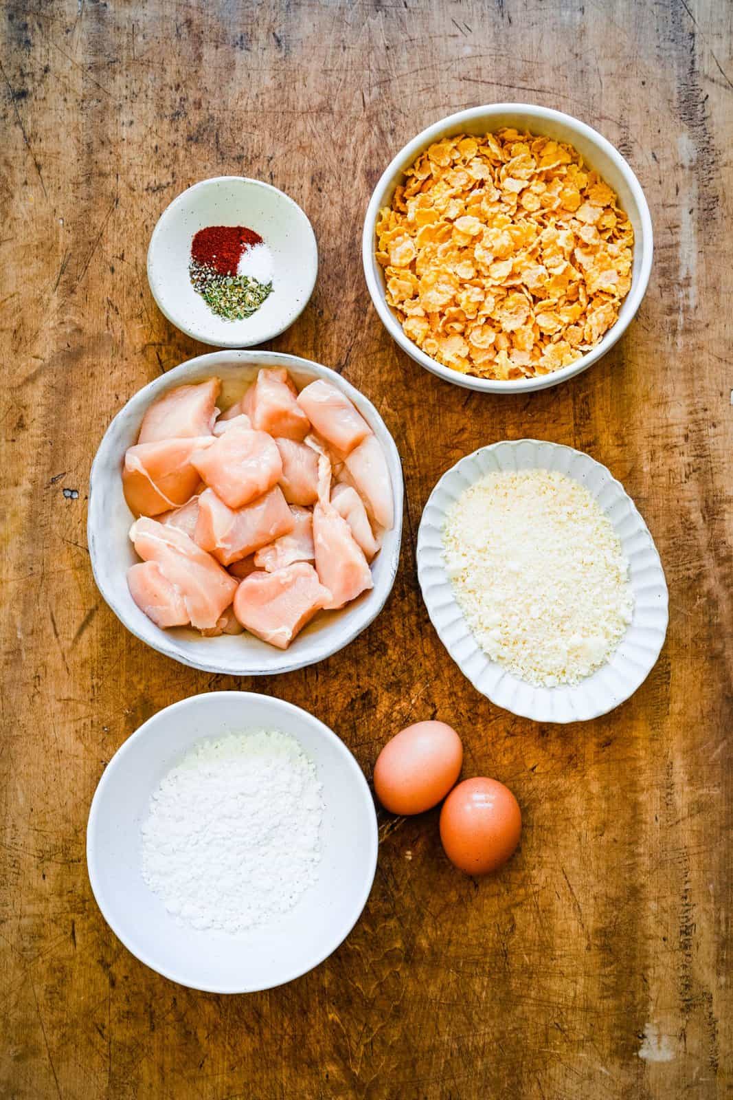 Ingredients needed: chicken breasts, eggs, cornstarch, cornflakes, grated parmesan, kosher salt, Italian seasoning, paprika and pepper.