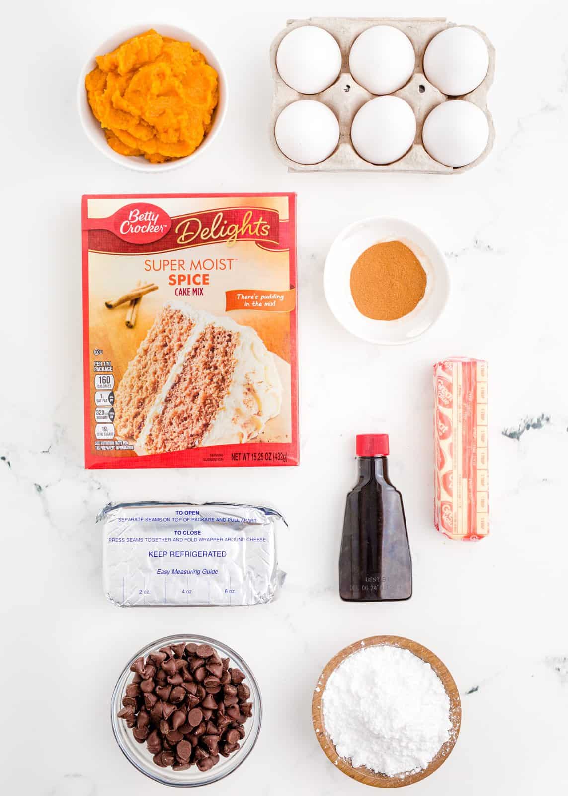 Ingredients needed: spice cake mix, pumpkin puree, cinnamon, eggs, cream cheese, salted butter, vanilla extract, powdered sugar and semi-sweet chocolate chips.