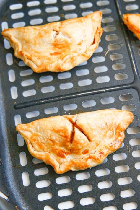 Finished hand pies in air fryer basket.