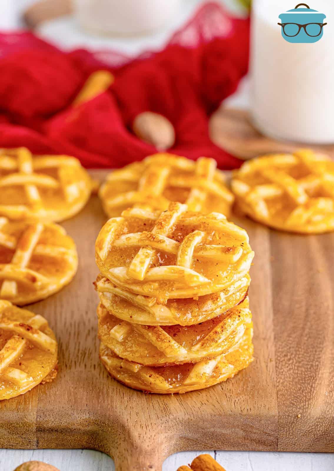 Stacked Easy Apple Pie Cookies on wooden cutting board.