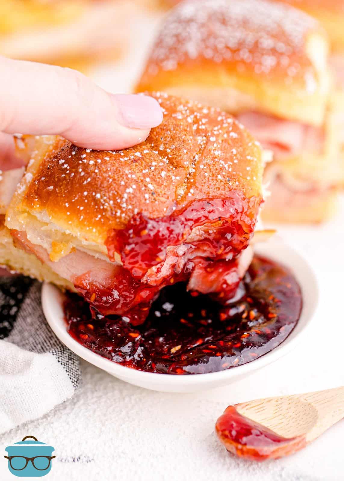 Hand dipping one of the Monte Cristo Sliders in the preserves.