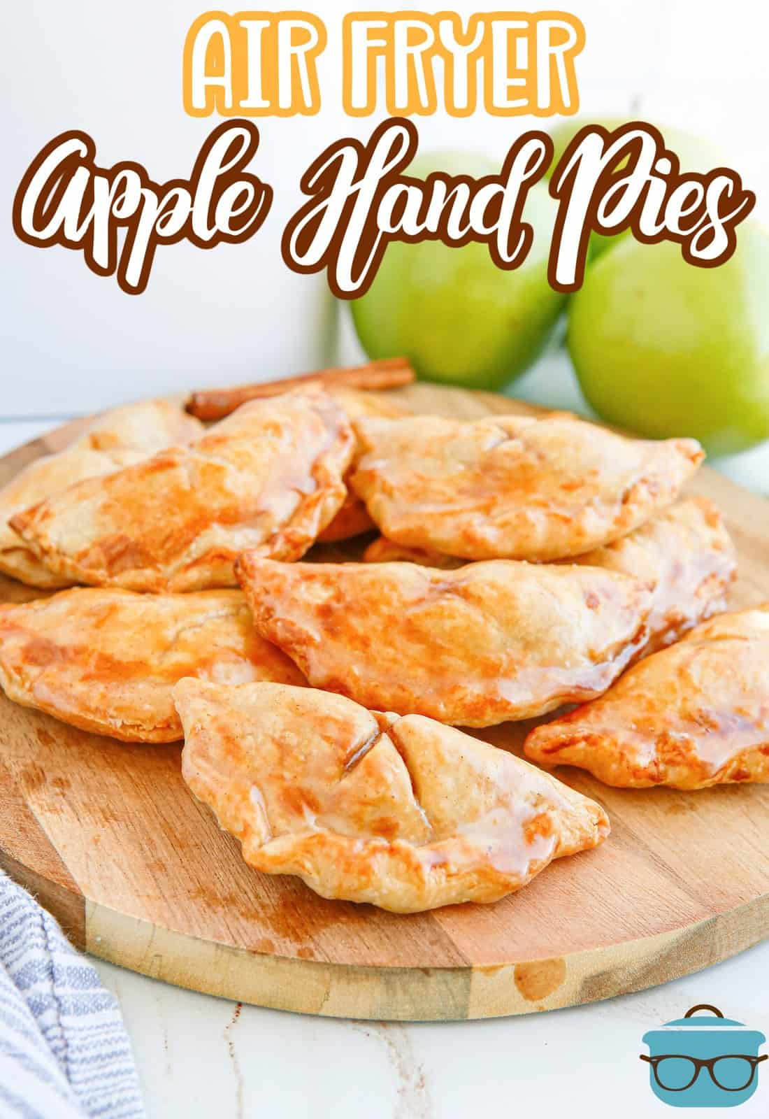 Pinterest image of Air Fryer Apple Hand Pies on wooden board glazed.