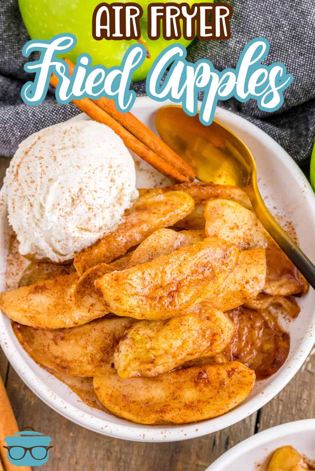 Overhead of Air Fryer Fried Apples in bowl with ice cream, cinnamon stick and spoon, Pinterest image.