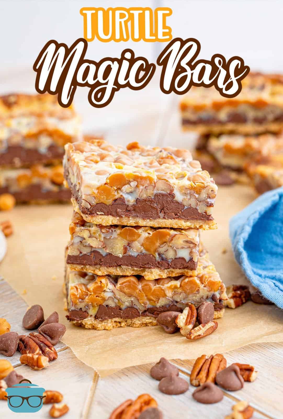 Pinterest image of three stacked Turtle Magic Bars on wooden board with chocolate chips and nuts in front.
