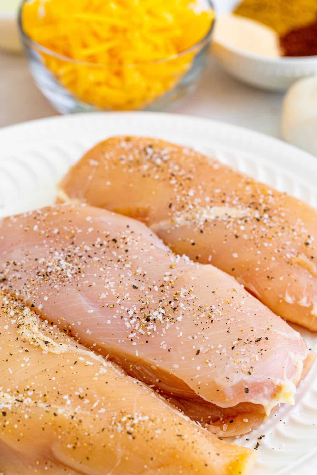Chicken breasts on plate seasoned.