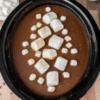 Square image close up overhead of Crock Pot Pumpkin Hot Chocolate with marshmallows.