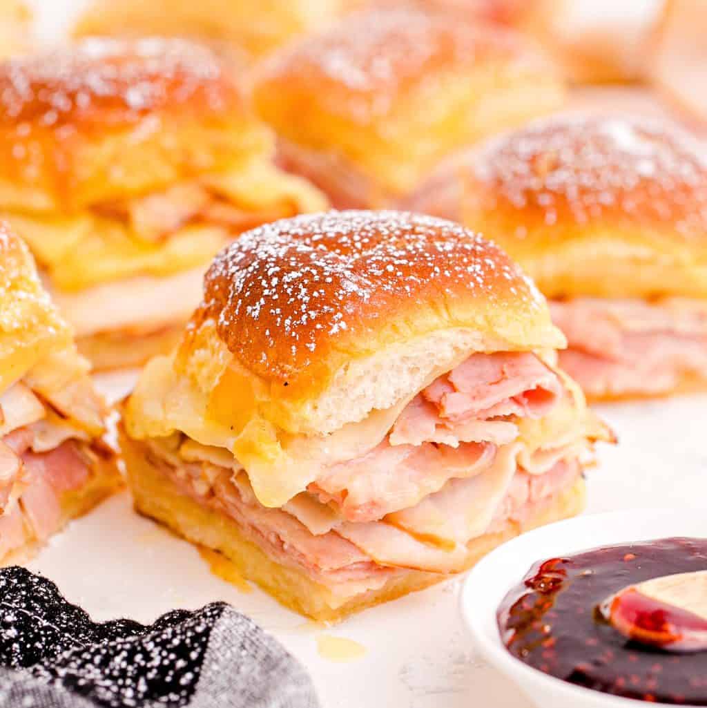 Close up square image of Monte Cristo Sliders with jam.