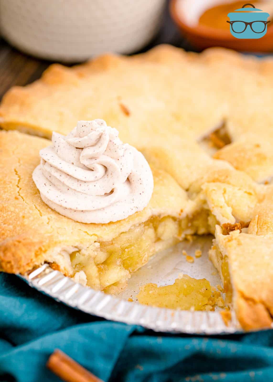 Swirl of the Homemade Cinnamon Whipped Cream on apple pie in pie tin.