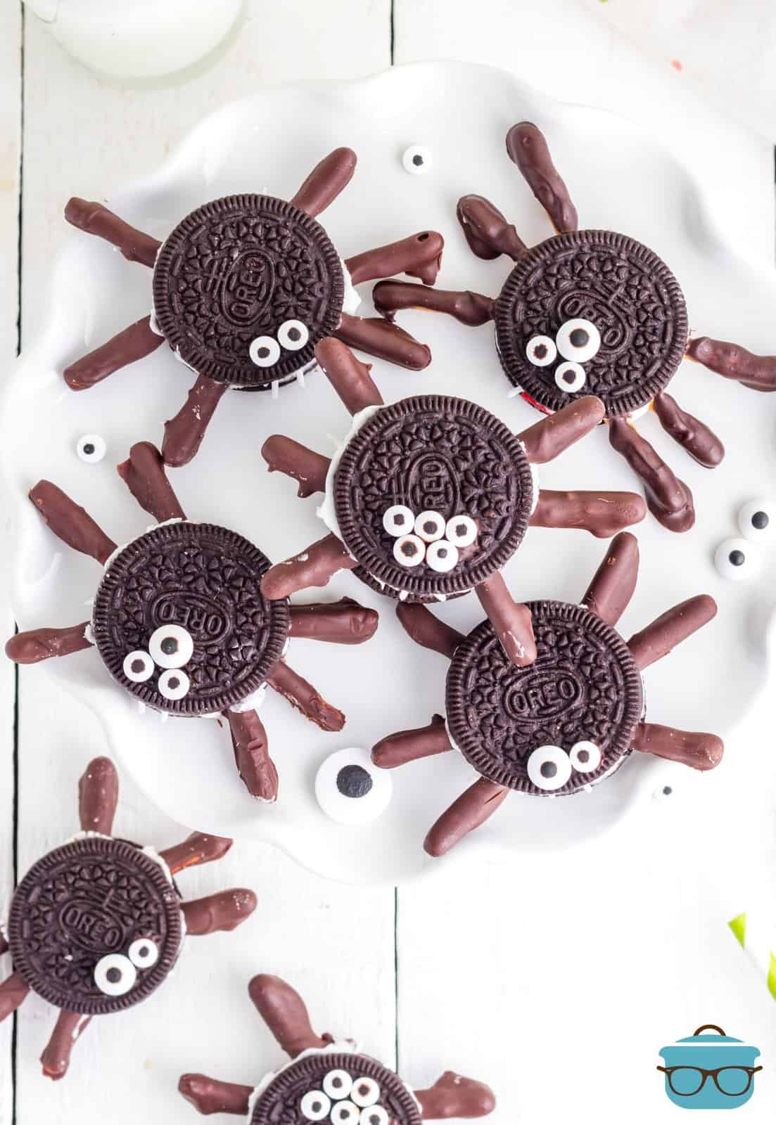 Overhead of Halloween Oreo Spiders on white plate showing eyes.