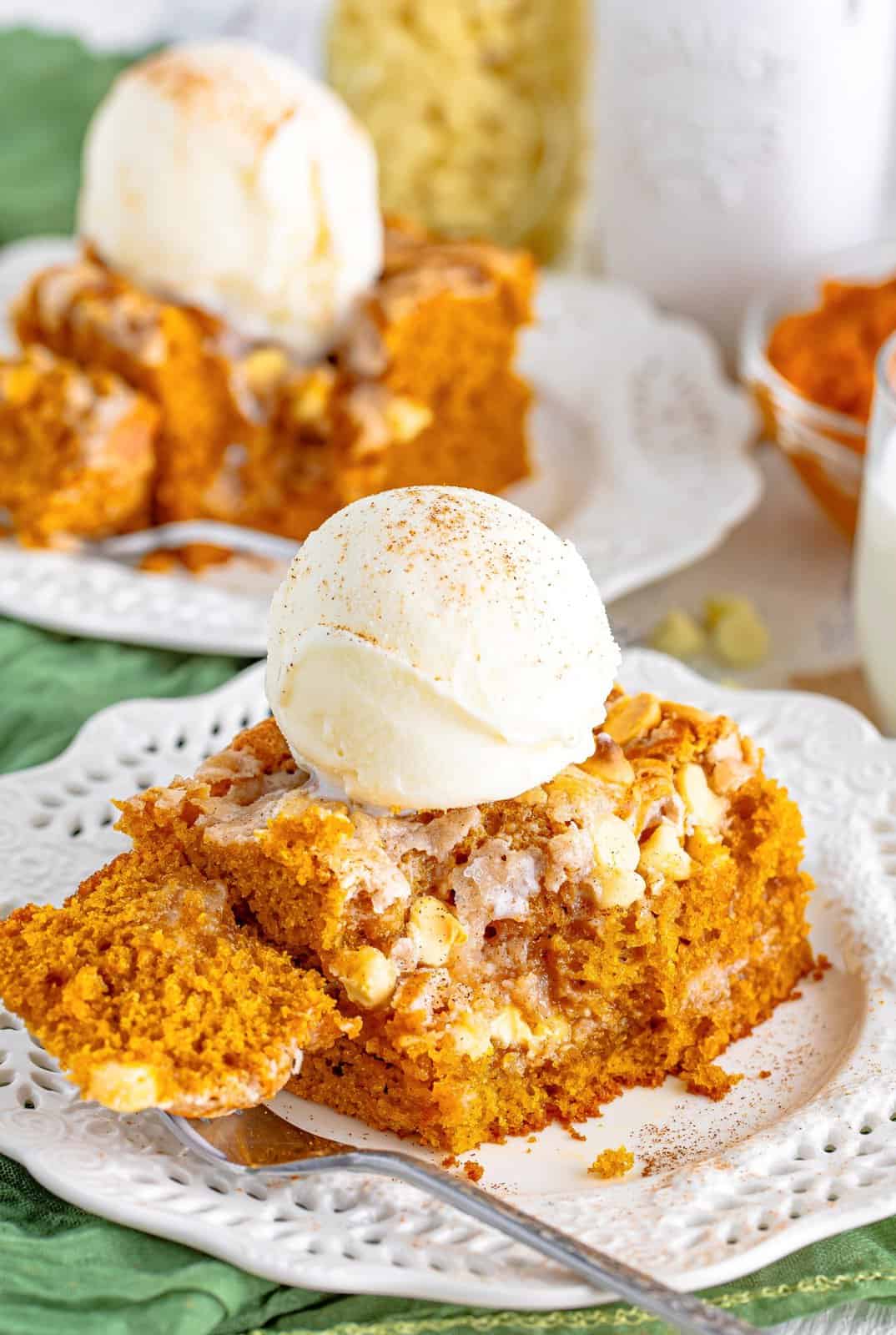 Pumpkin Earthquake Cake with bite taken out of it topped with ice cream.