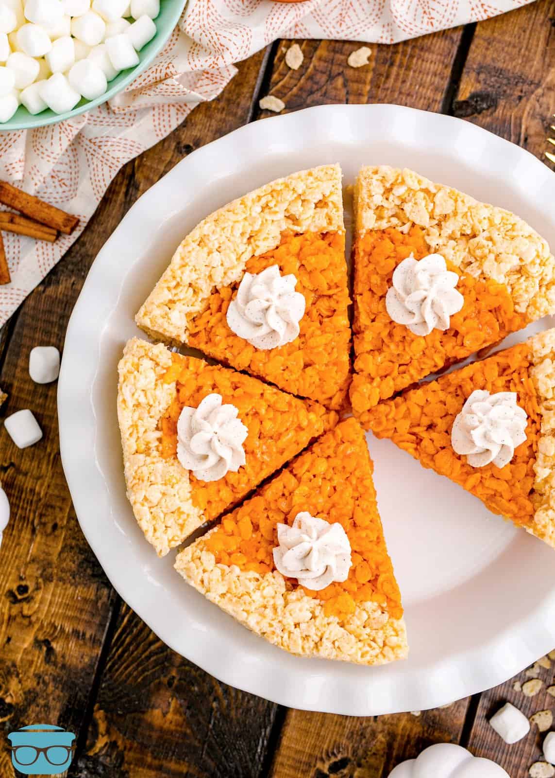 Overhead of Pumpkin Pie Rice Krispies Treats in pie plate with slice missing.