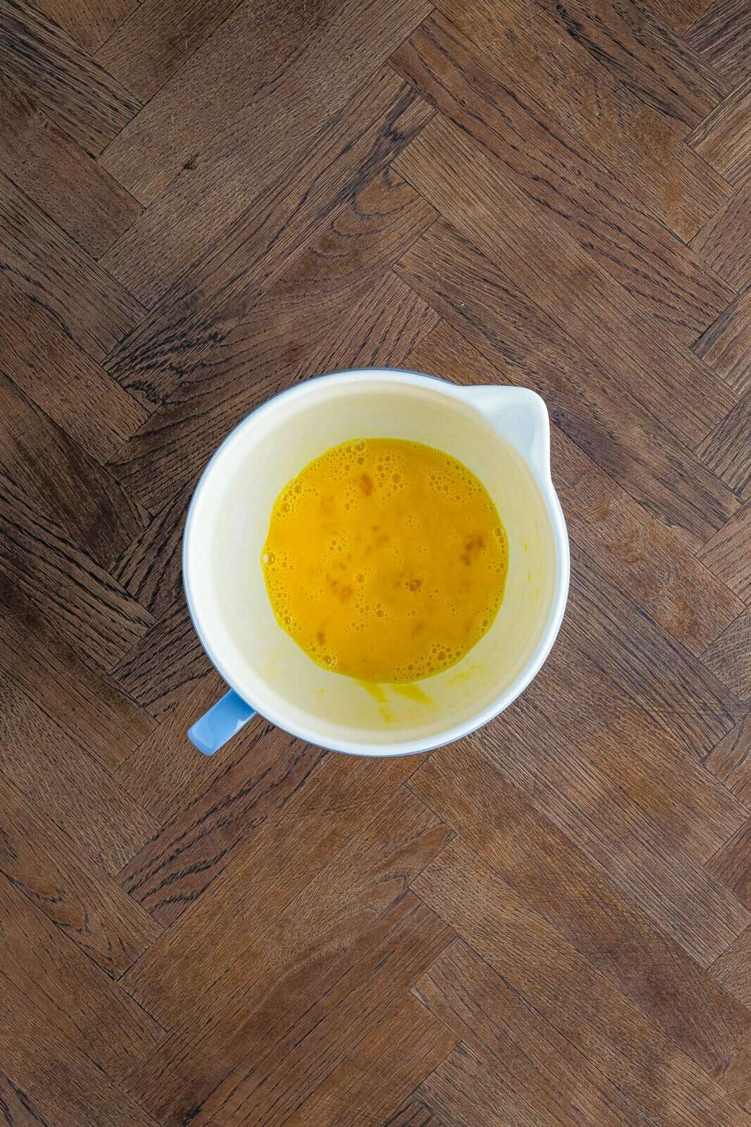 Eggs whisked together in bowl.
