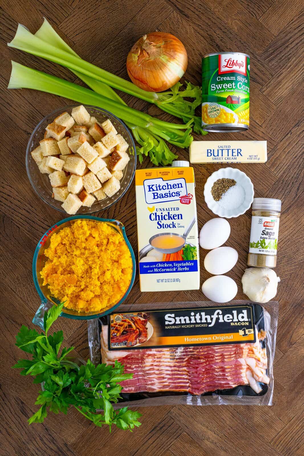 Ingredients needed: bacon, sweet onion, celery, ground sage, kosher salt, pepper, garlic, cornbread, day-old white bread, parsley, eggs, creamed corn, unsalted chicken stock and salted butter.
