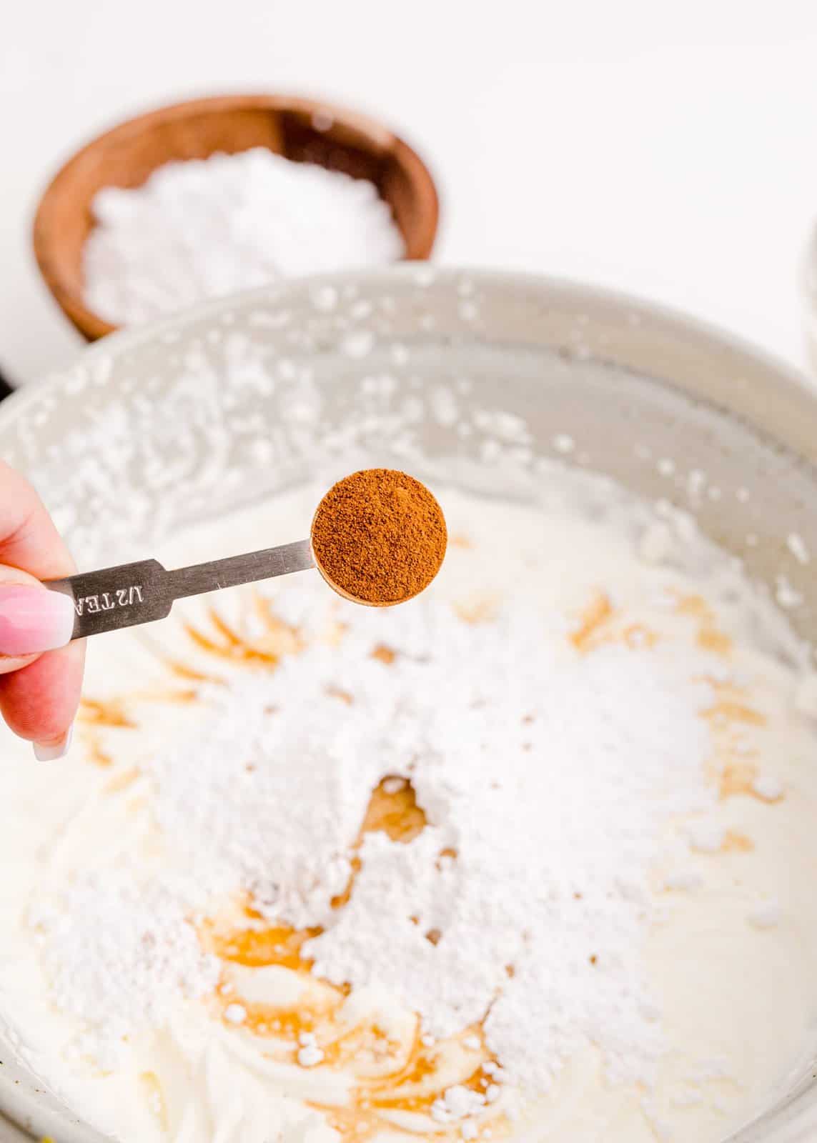 Powdered sugar, vanilla extract and cinnamon added to semi beaten whipped cream.