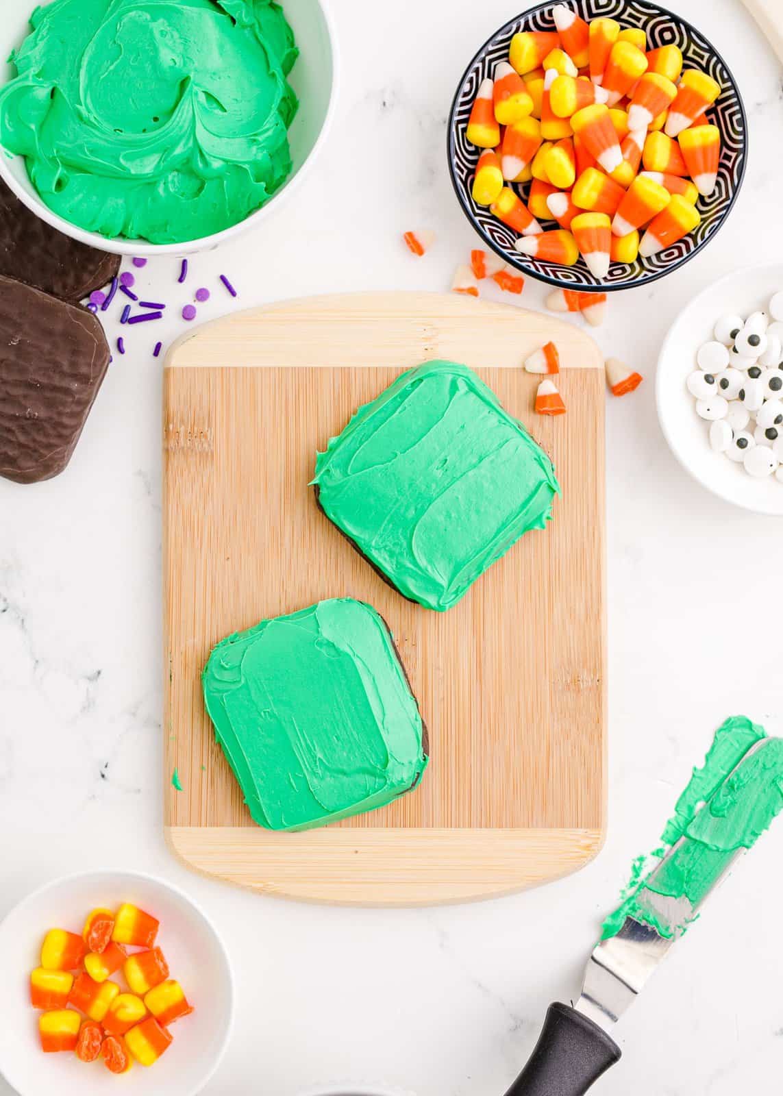 Green frosting spread over cookies.
