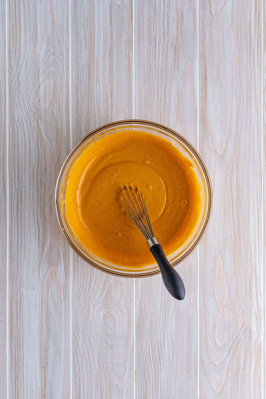 Pumpkin pudding whisked together in bowl.