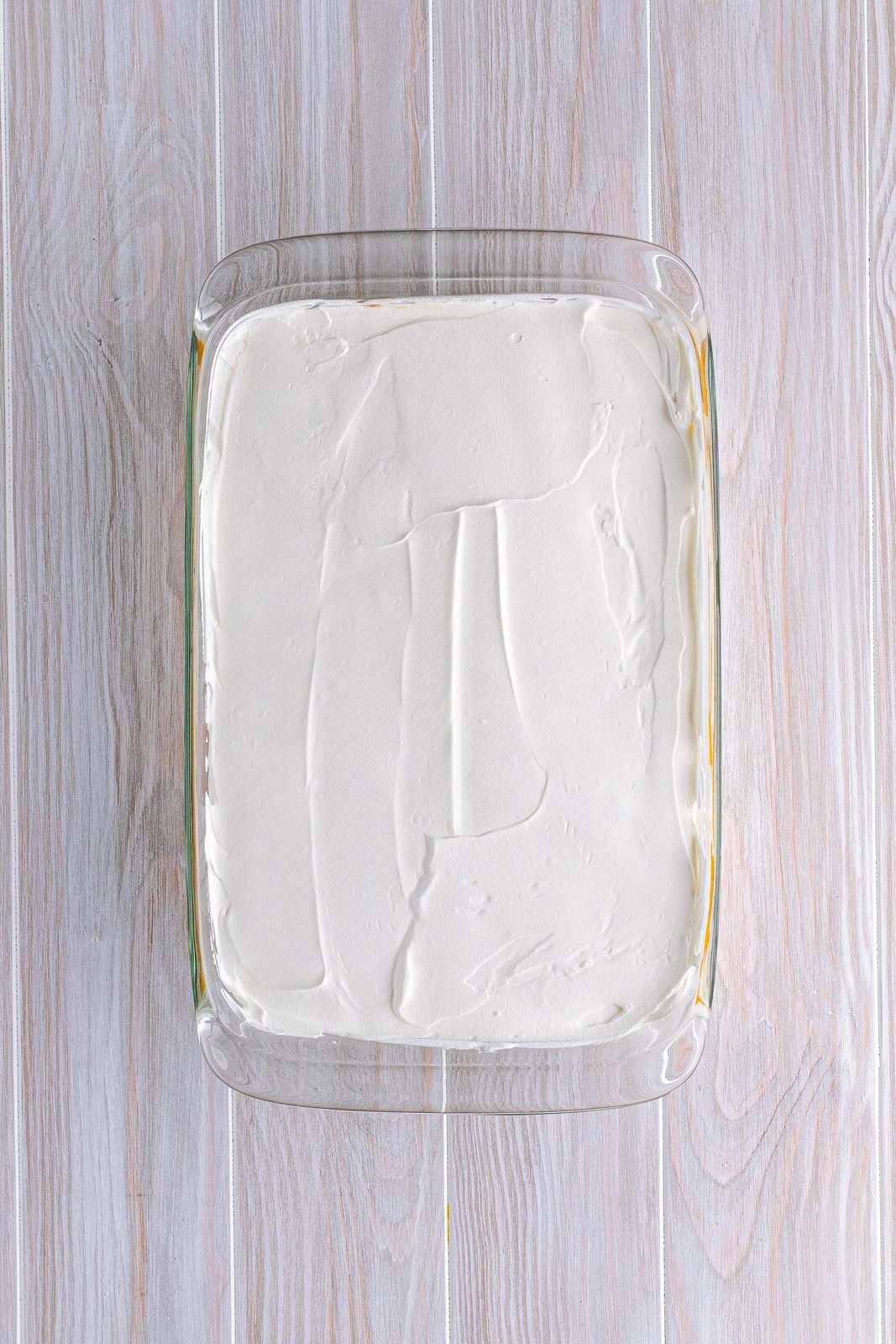 Pudding topped with whipped topping.