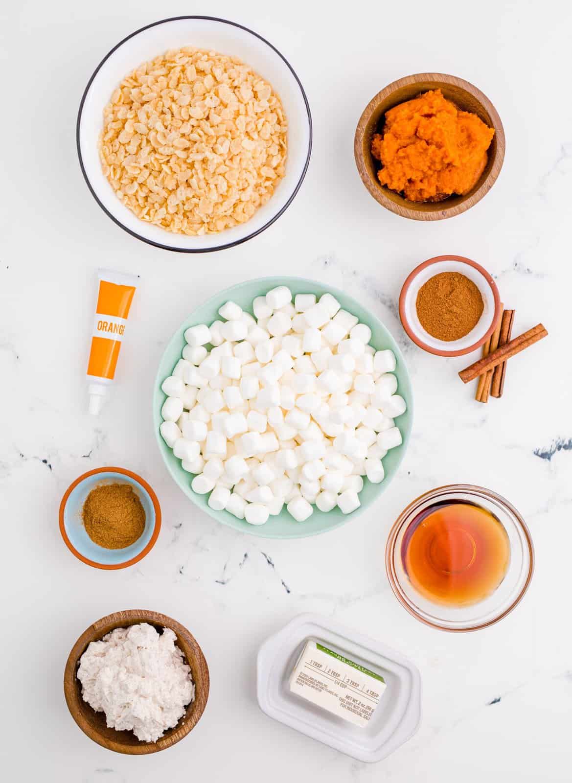 Ingredients needed: salted butter, mini marshmallows, maple syrup, Rice Krispies, pumpkin pie spice, pumpkin puree, cinnamon, orange food coloring and cinnamon whipped cream, optional.