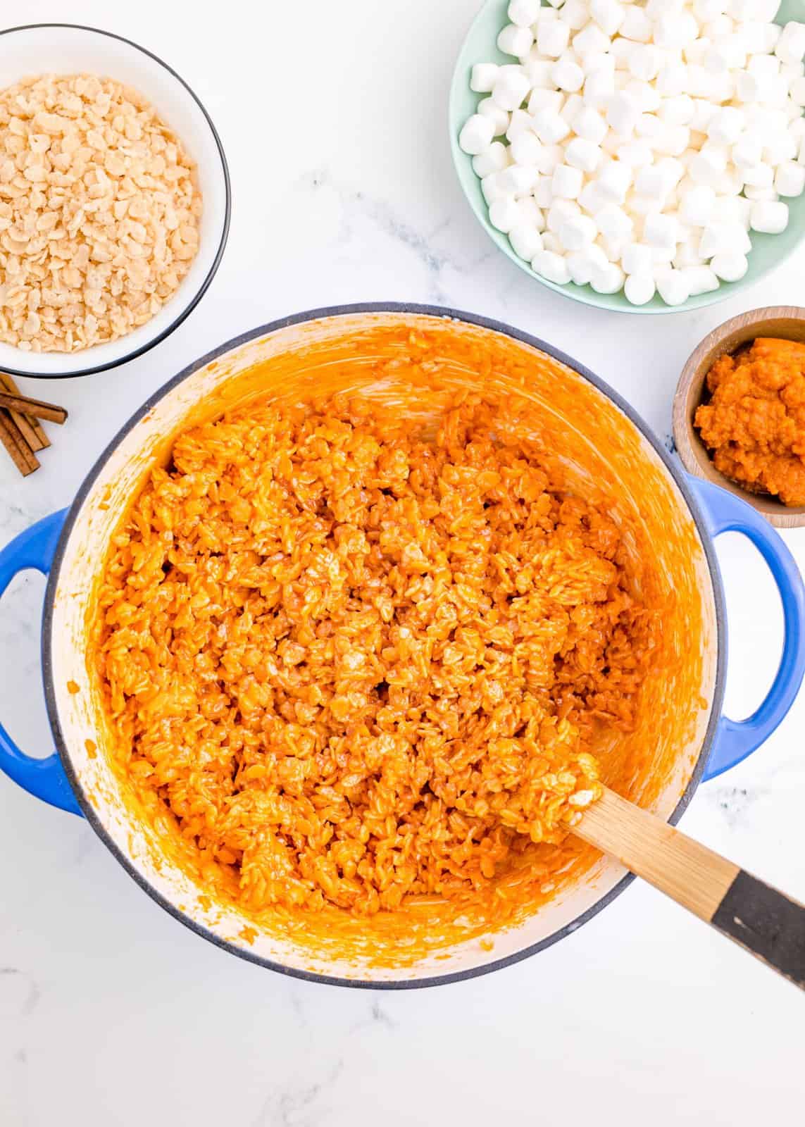 Orange food coloring mixed in with Rice Krispies until everyone is coated.