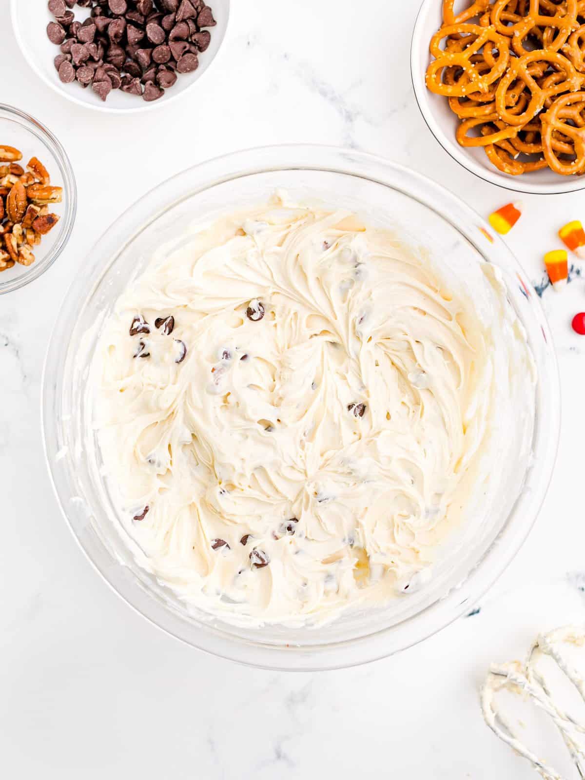 Brown sugar, vanilla, pecans and chocolate chips mixed into the cream cheese mixture in bowl.