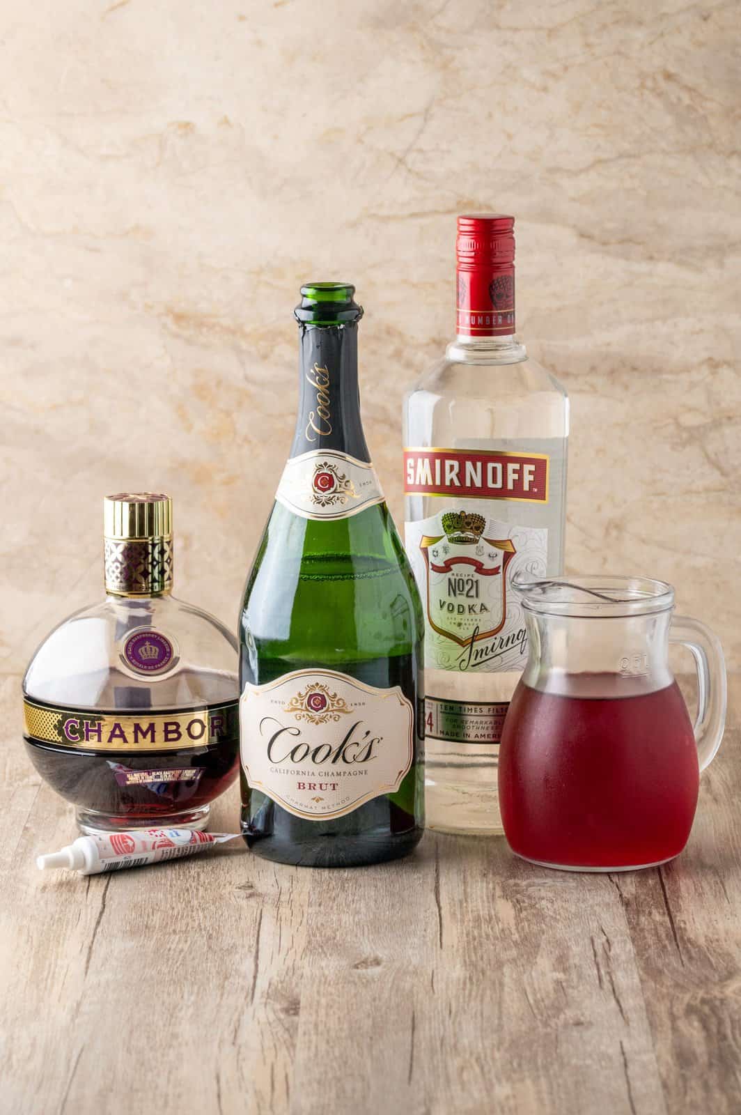 Ingredients needed: red decorating gel, vodka, raspberry liqueur, cranberry juice and champagne.
