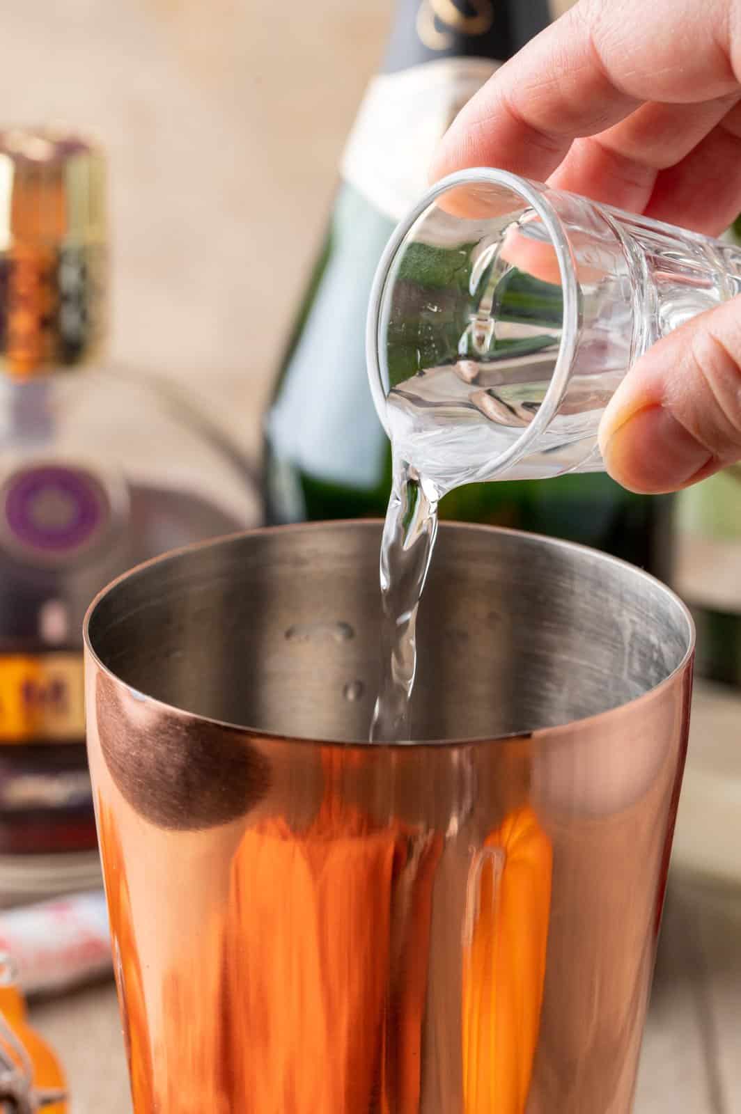 Vodka be poured into cocktail shaker.