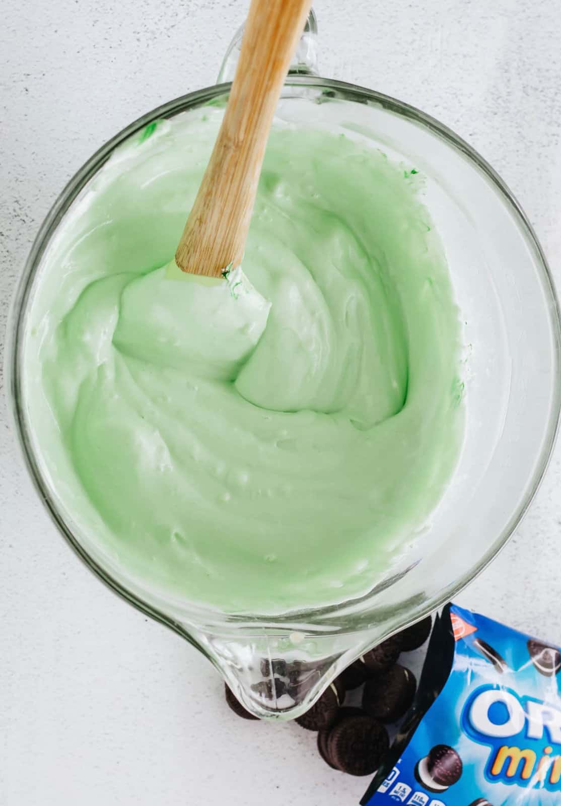 Cool whip and green food coloring folded into the pudding mixture.