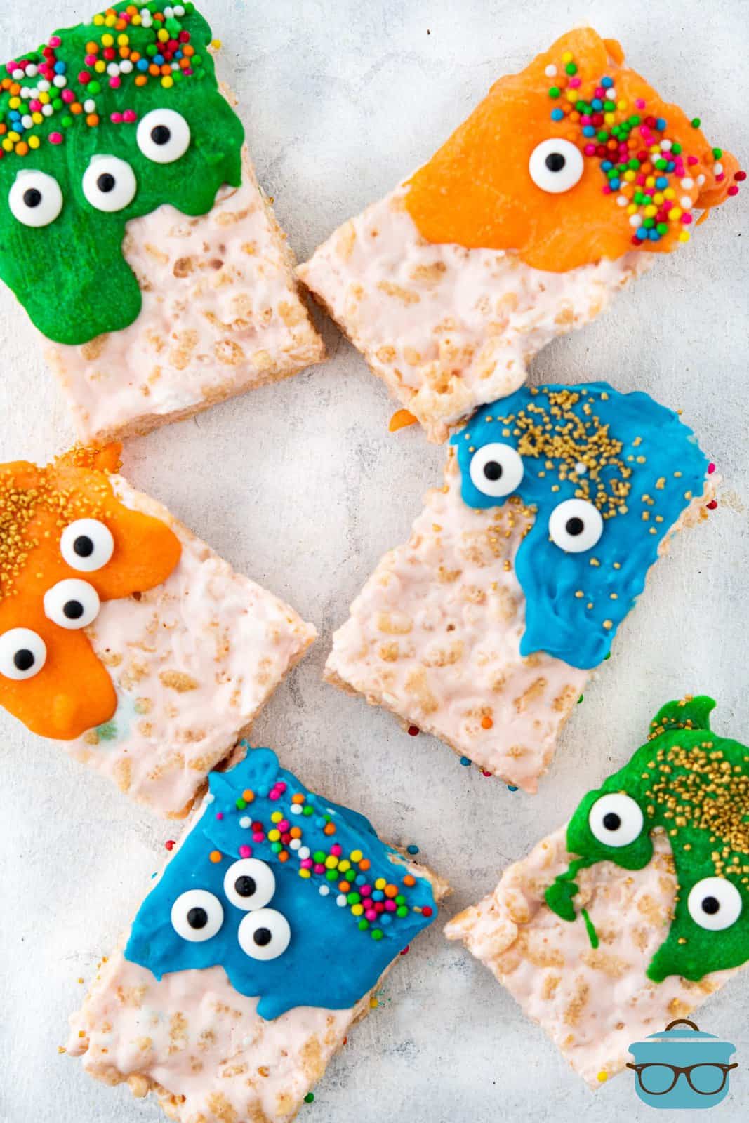 Overhead of decorated Halloween Rice Krispies Monsters on parchment paper.