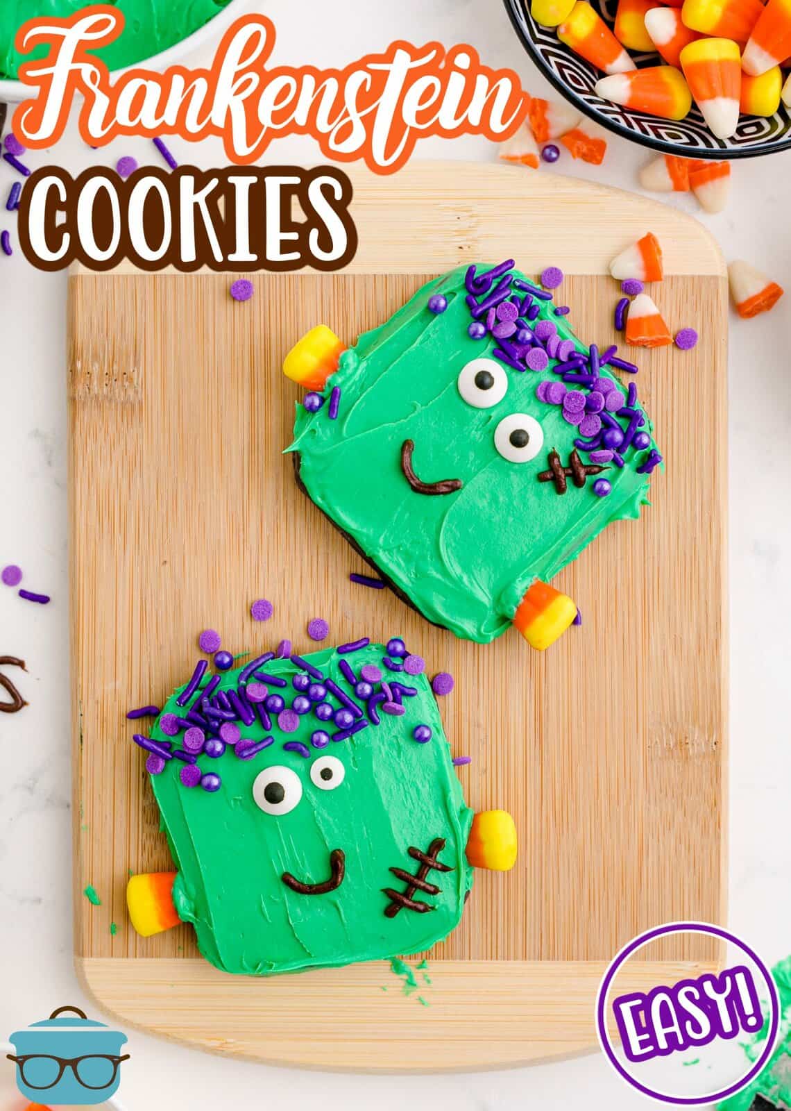 Pinterest image of two Easy Frankenstein Cookies on wooden cutting board with candy corn.