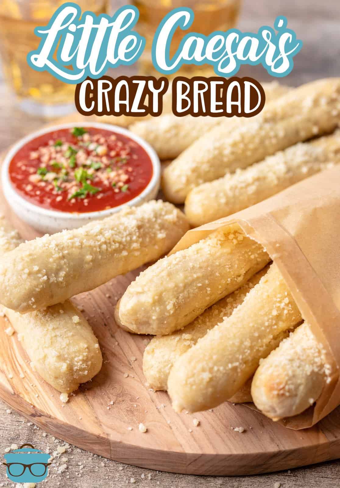 Pinterest image of Copycat Little Caesar's Crazy Bread on wooden board with dipping sauce.