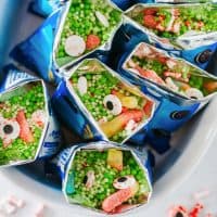 Close up overhead square image of Witches Brew Snack Bags in white dish.