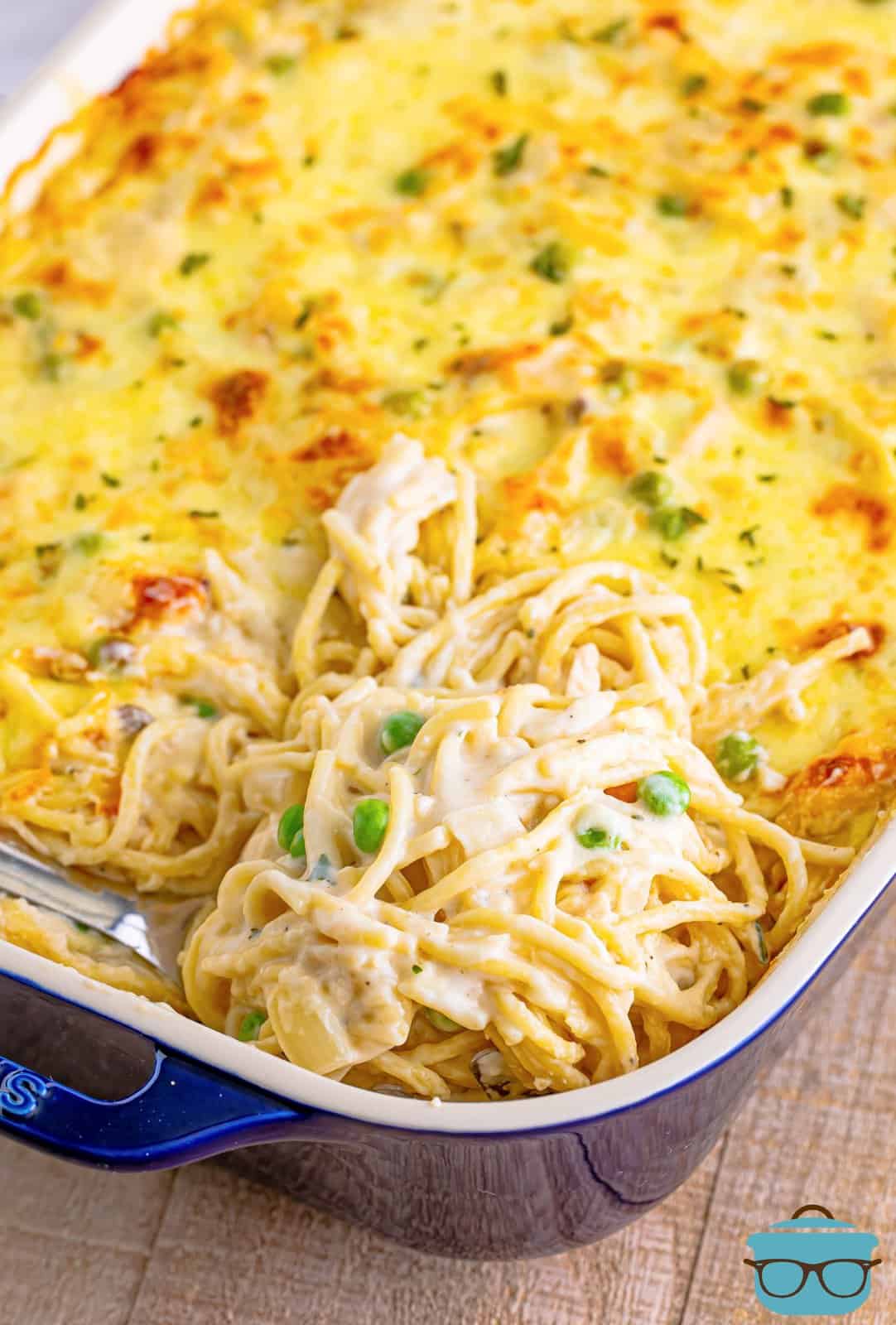 Serving spoon in baking dish with Easy Chicken Tetrazzini.