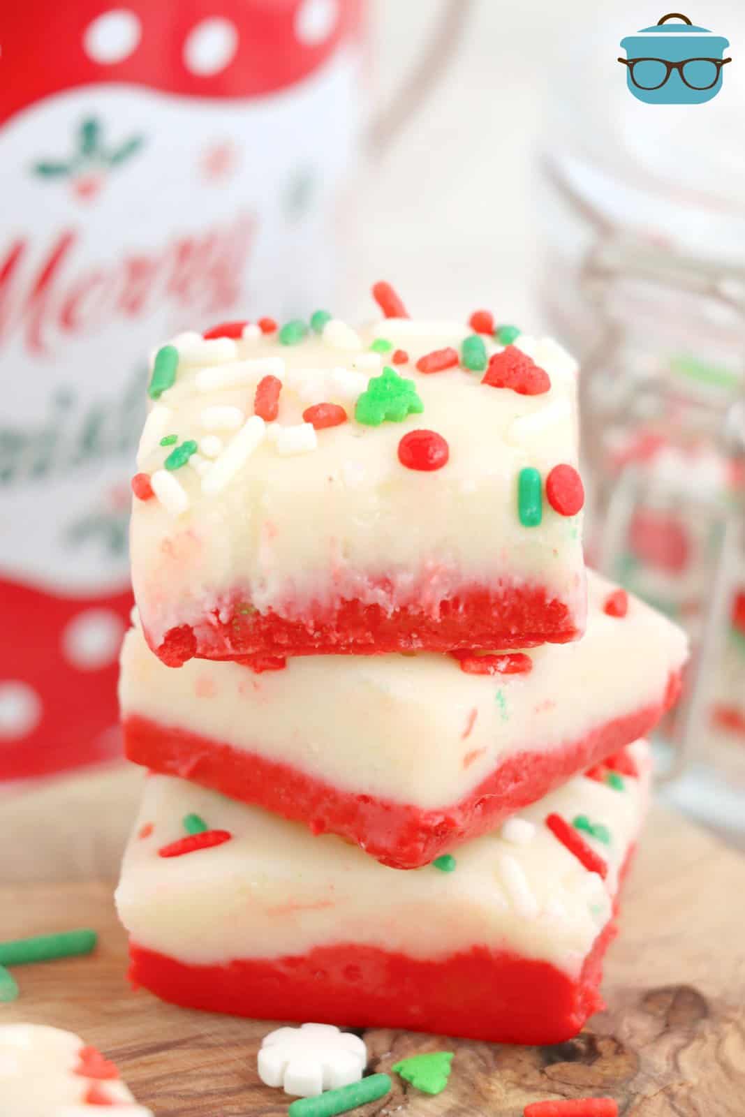 Three stacked pieces of Christmas Cake Batter Fudge.