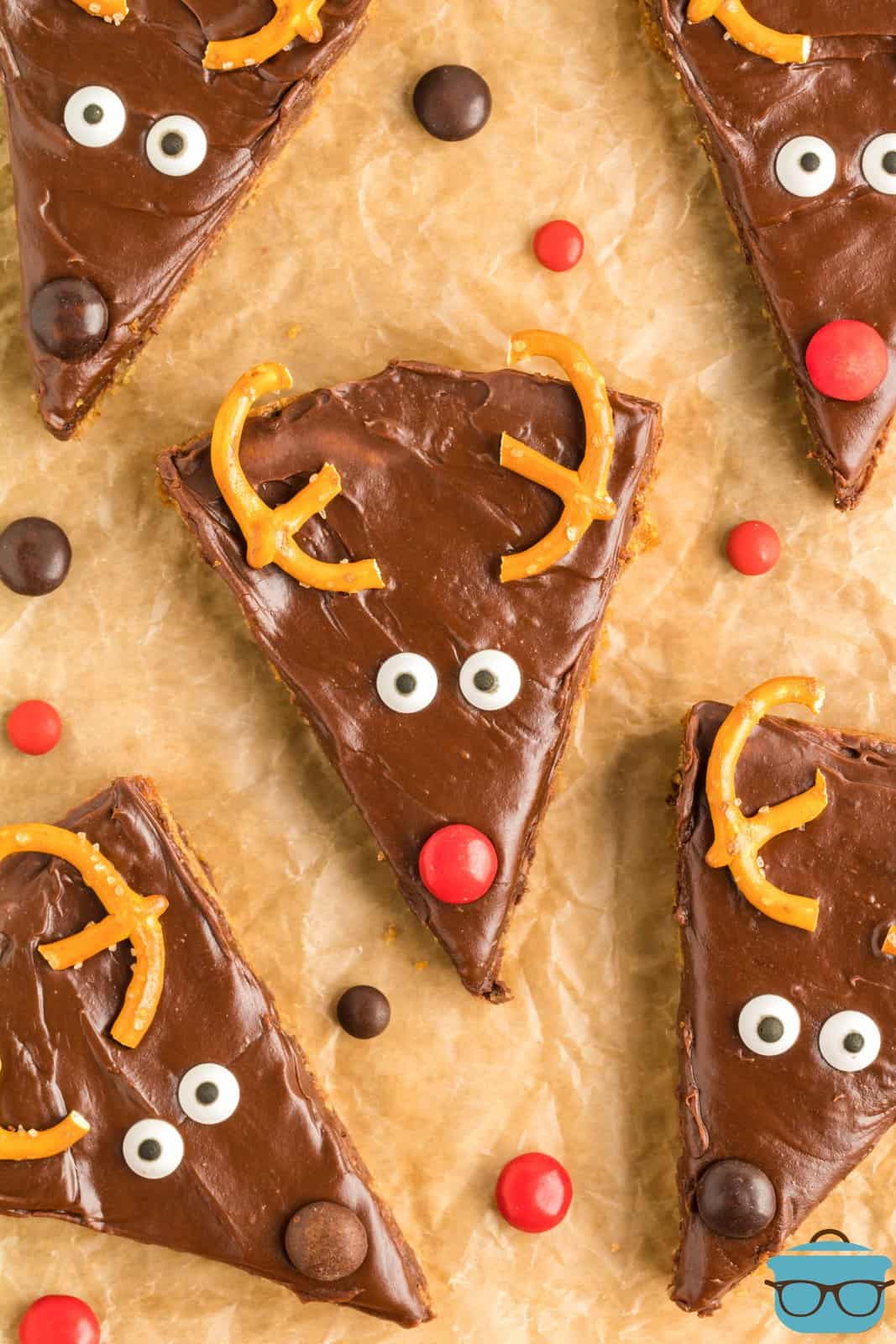 Overhead of decorated Reindeer Cookie Bars on brown parchment paper.
