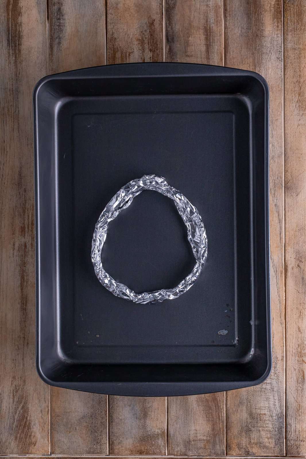 Tin foil ring placed into bottom of baking pan.