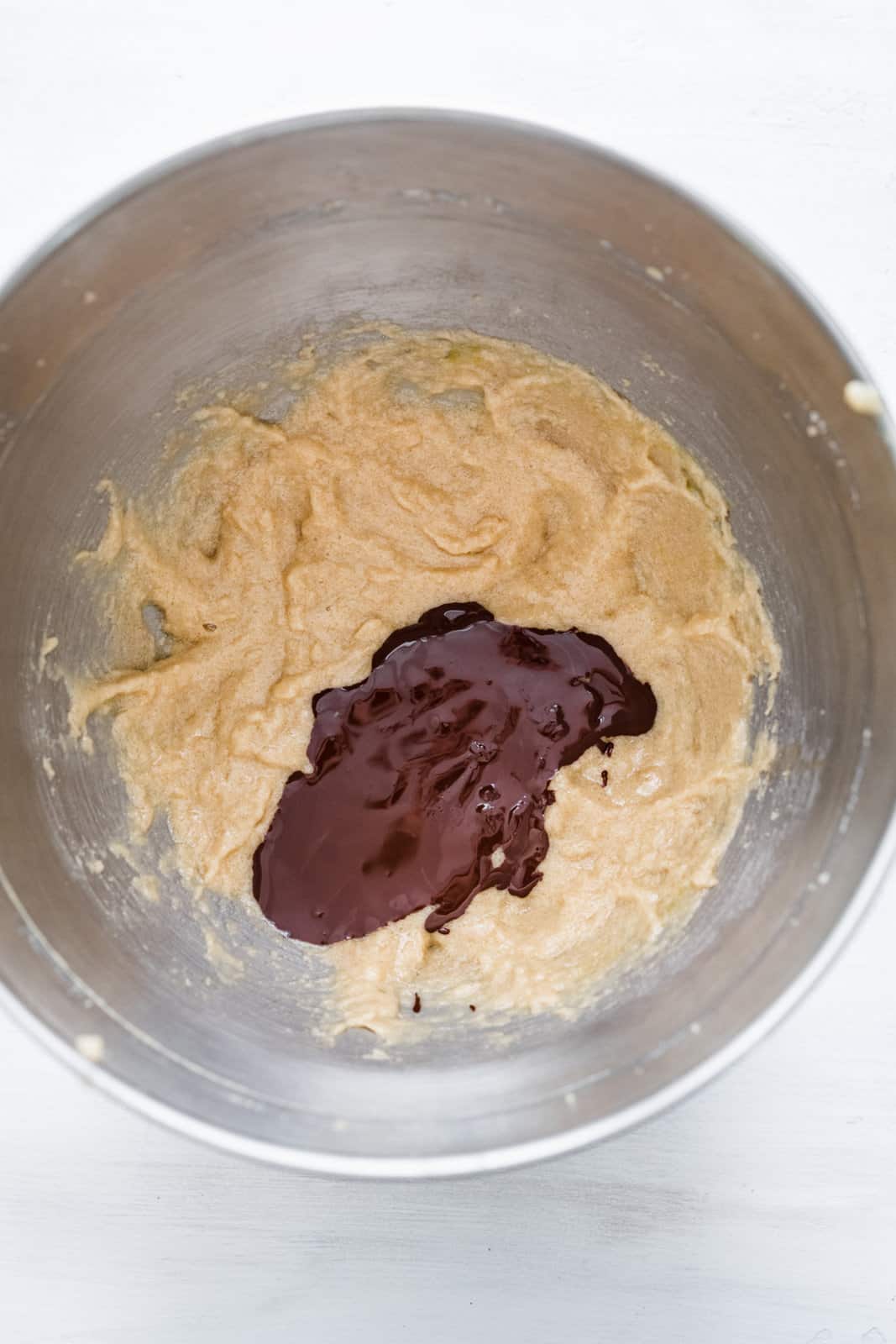 Melted chocolate added to the bowl of the stand mixer.