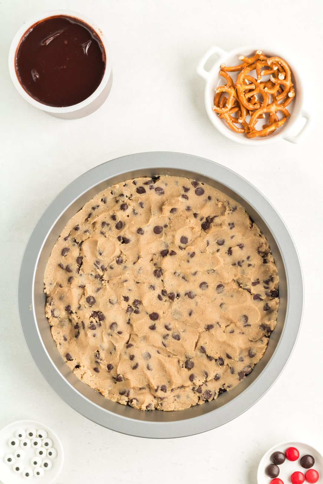 Cookie dough pressed into round baking pan.